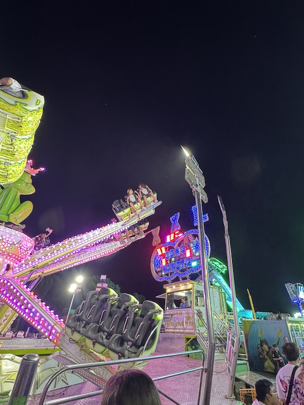 Laia and Sofia riding the carnival attractions
